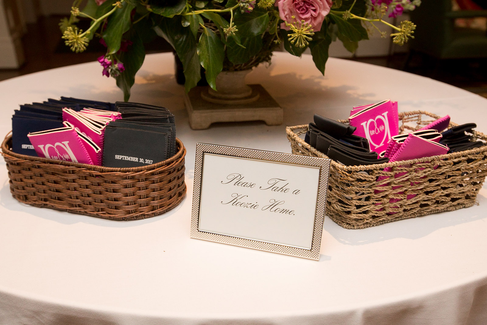 Koozies with logo in baskets at wedding