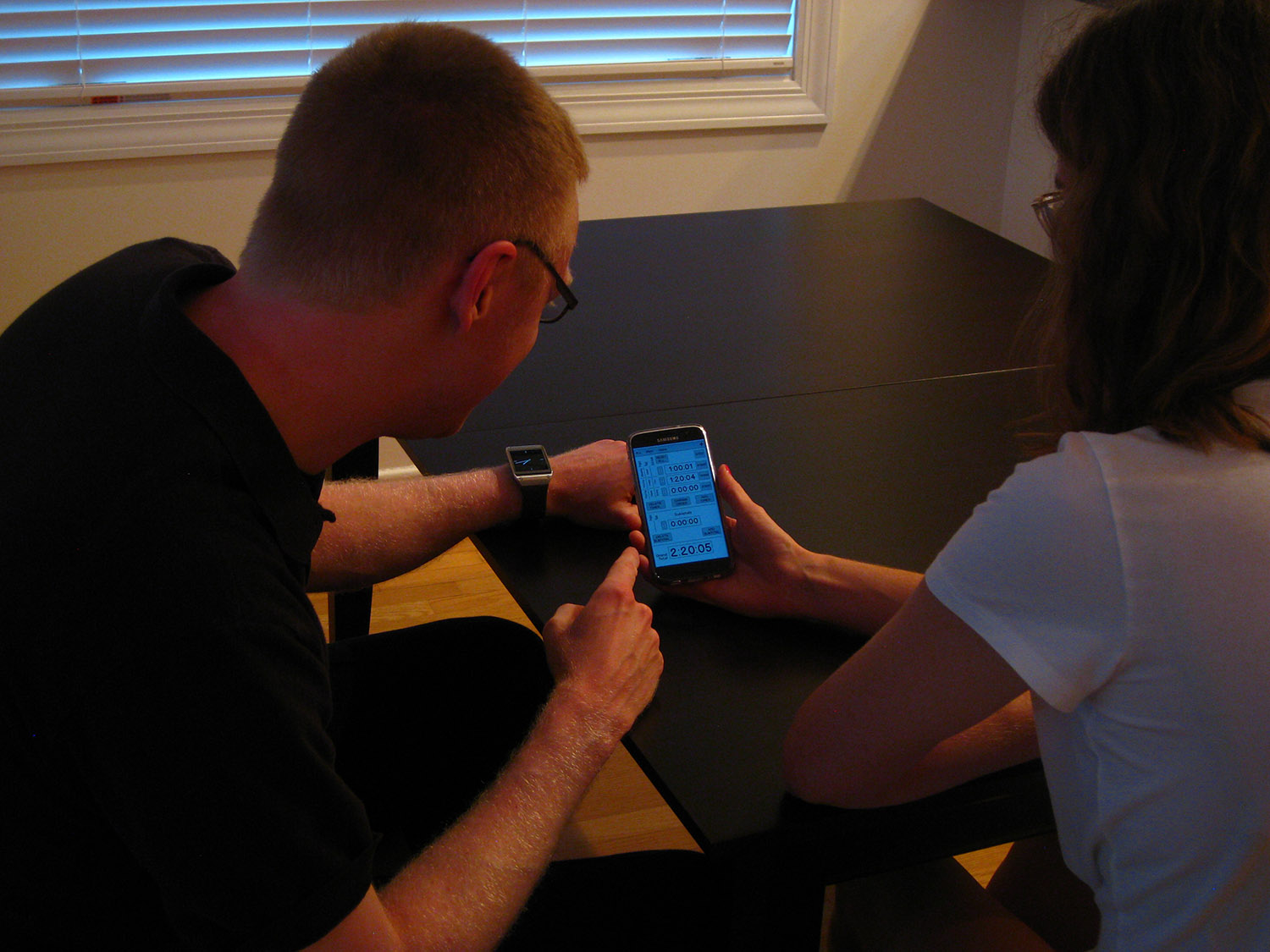 Interviewing a user - phone in hand with prototype on screen